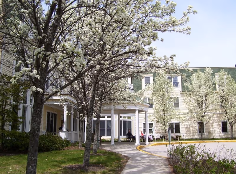 Exterior view of Gorham House with a tree-lined walkway and front entrance.