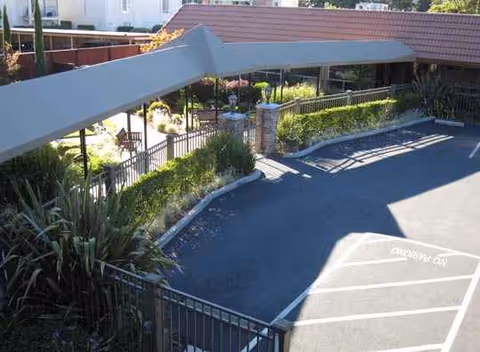 Exterior view of WaterLeaf at Land Park with a covered walkway and parking area.