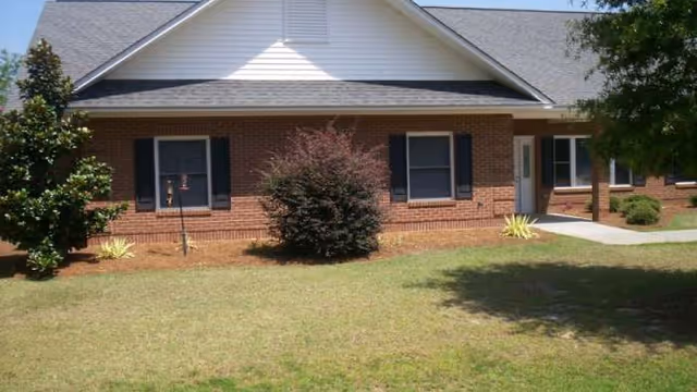 Exterior view of Aldersgate Special at the Oaks, brick building with front yard.