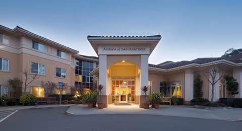 Front entrance of AlmaVia of San Francisco, a modern senior living campus with landscaping.