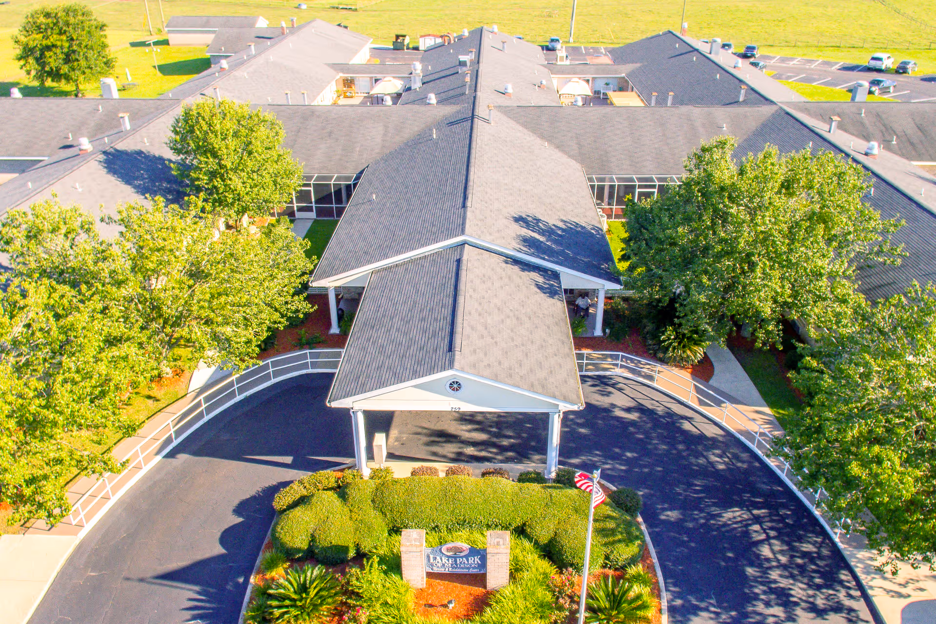 Aerial view of the Lake Park of Madison Nursing and Rehabilitation building with a circular driveway and landscaped entrance.