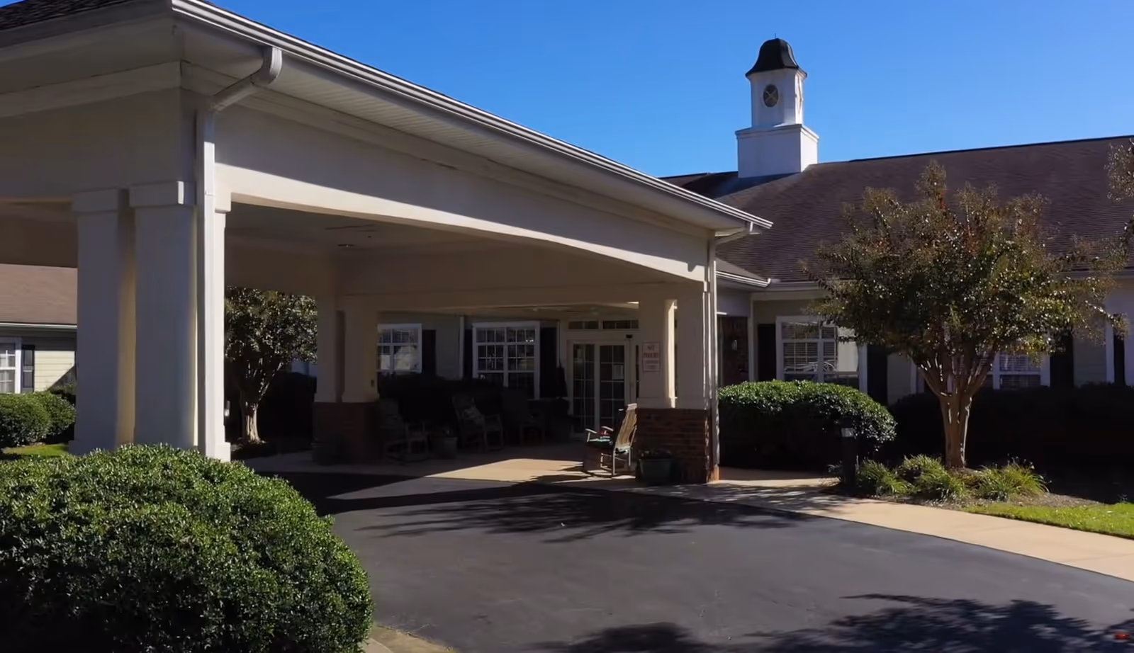 Front view of Viva Senior Living at Easley entrance with covered drop-off and landscaping
