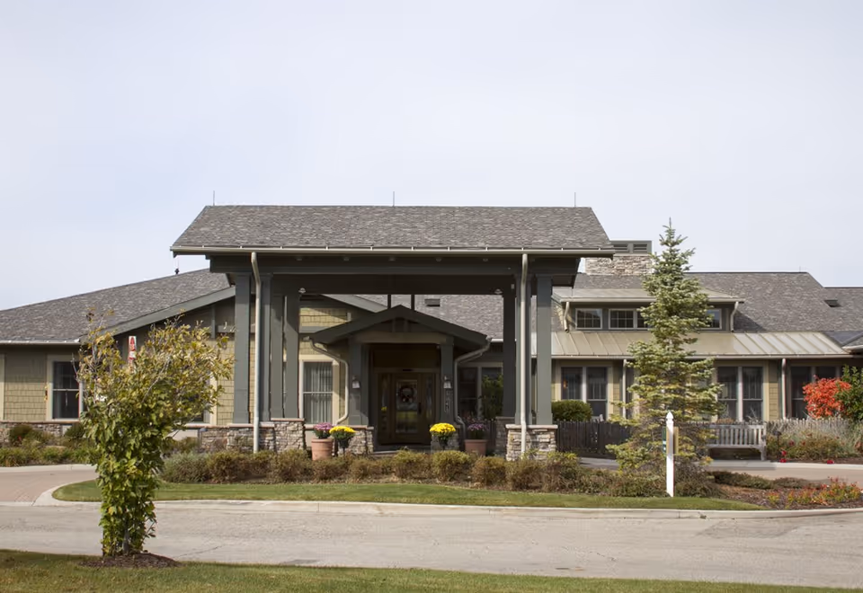 Front view of Sunrise of Cascade senior living facility with a covered entrance and landscaped surroundings.