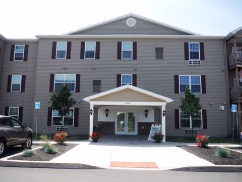 Front view of Park Terrace at Radisson senior living building with entrance canopy.