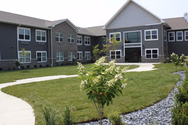 Exterior view of Autumn Trace Columbia City Assisted Living building with landscaped lawn.
