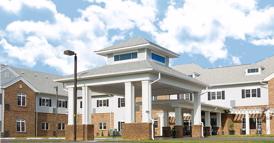 Front view of English Meadows Blacksburg Campus with a covered entrance and brick facade.
