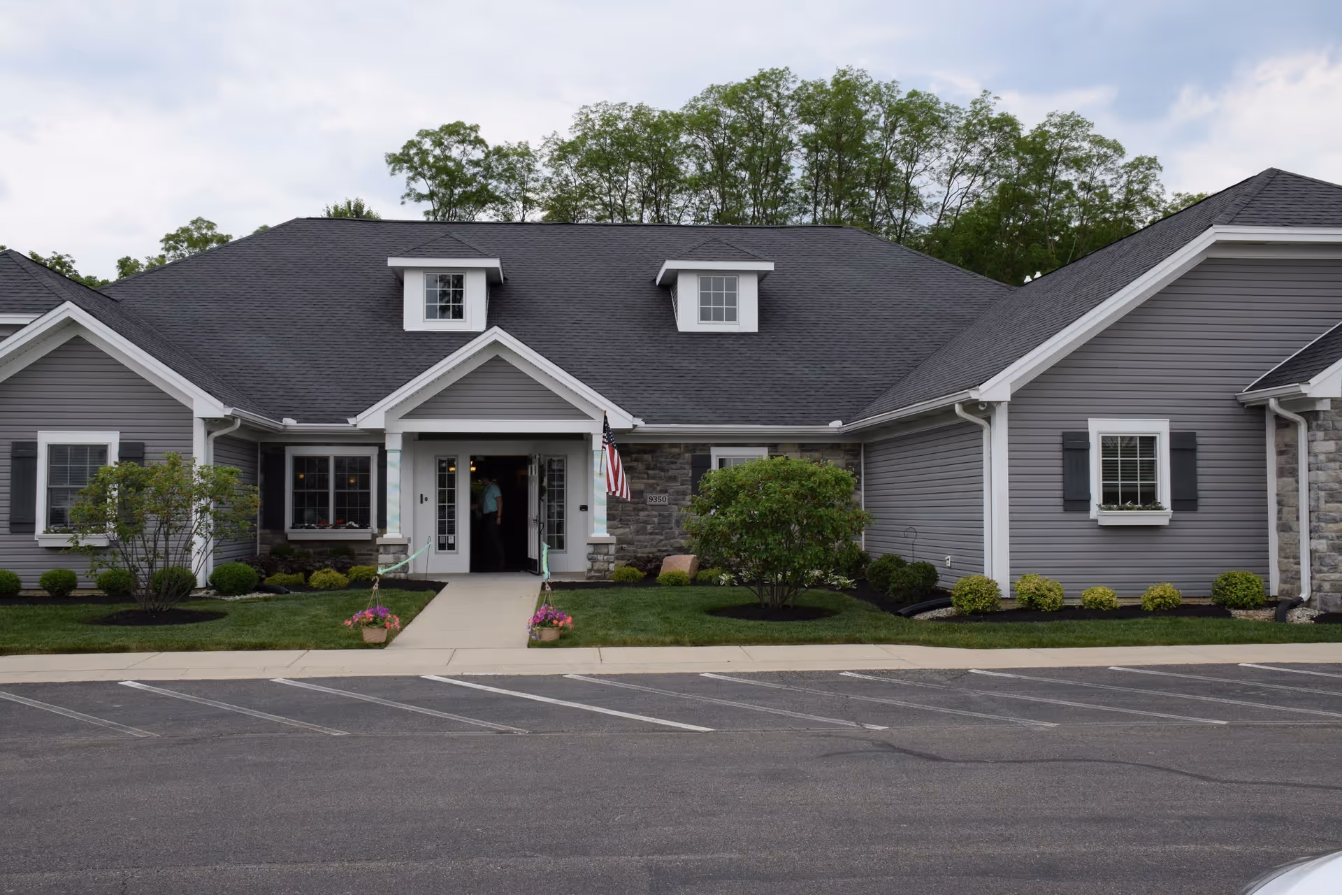 Exterior view of the Otterbein Middletown SeniorLife Neighborhood building with a well-kept garden.