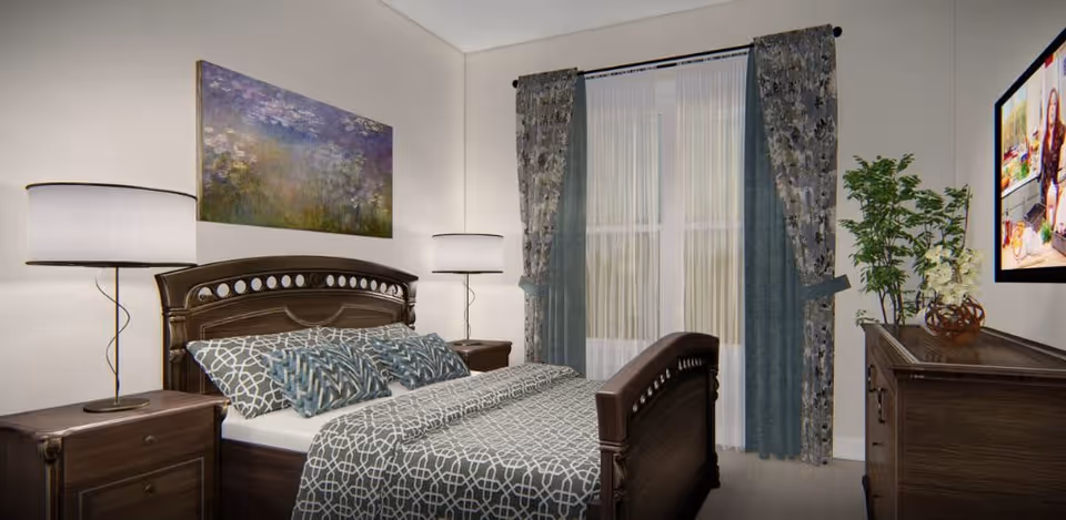 A bedroom with a wooden bed frame and matching nightstands on either side, each with a lamp. The bed is made with patterned bedding and several pillows. A large window with sheer white curtains and blue patterned drapes is behind the bed. A dresser with a plant and decorative items is on the right side, and a flat-screen TV is mounted on the wall above it. A colorful painting hangs above the bed.