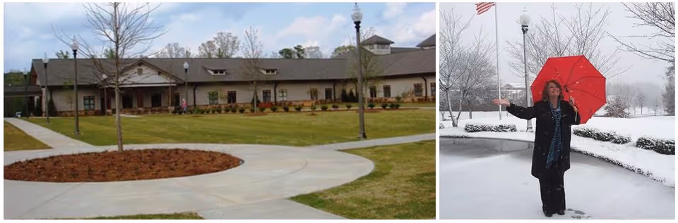 Exterior view of a senior living building with landscaped walkways on the left and a person holding a red umbrella standing in falling snow on the right.