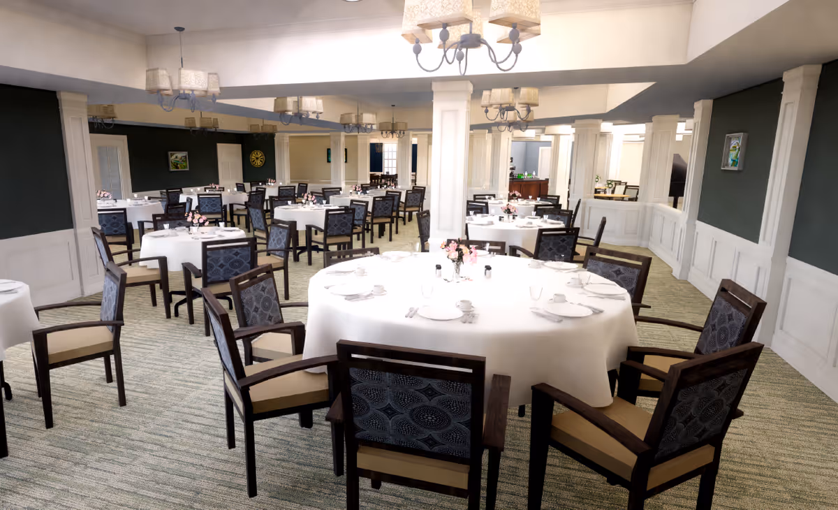 A spacious dining room with multiple round and square tables covered with white tablecloths, each set with plates, cups, and silverware. The room features dark green walls with white wainscoting, several chandeliers hanging from the ceiling, and patterned chairs arranged around the tables.