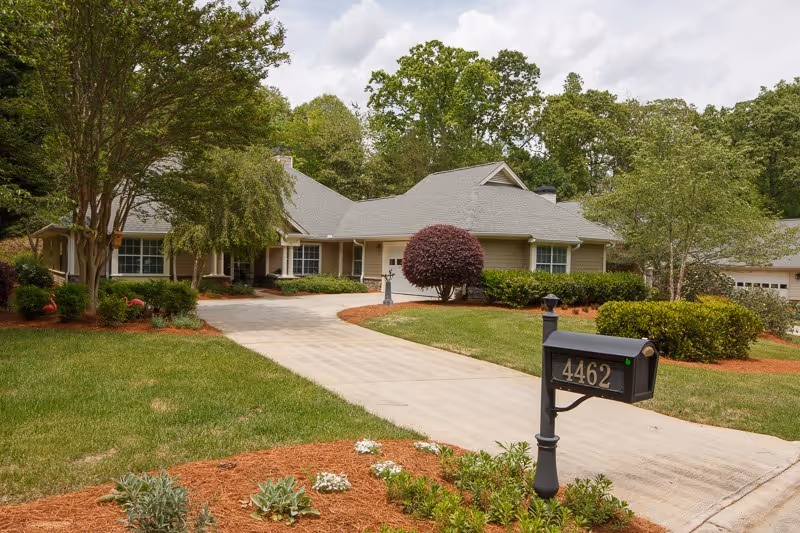 Front exterior of a single-story house with a driveway, mailbox numbered 4462, and landscaped lawn.