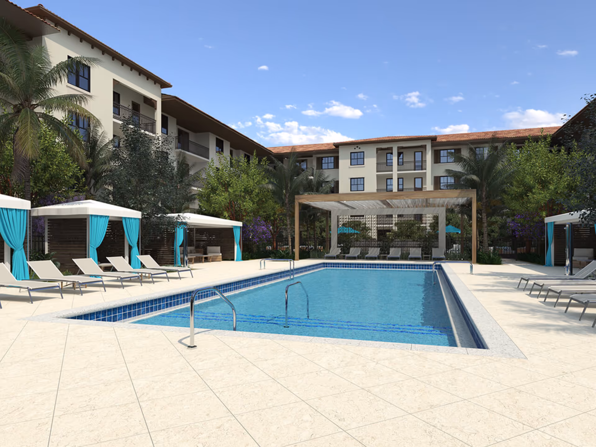 Outdoor swimming pool area at The Residences at Monterra Commons featuring lounge chairs, cabanas with turquoise curtains, palm trees, and a three-story building in the background under a blue sky with scattered clouds.