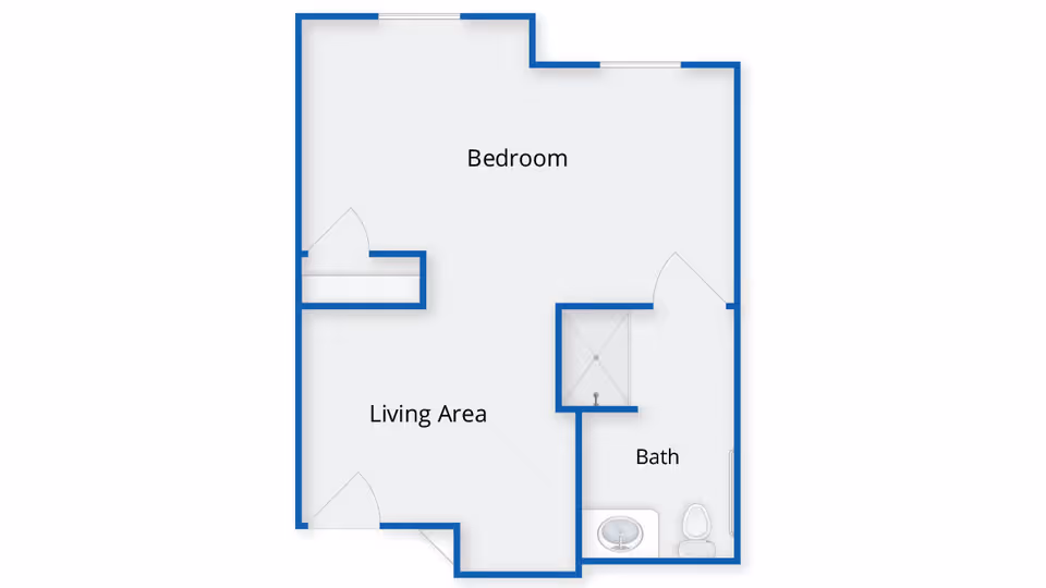 Floor plan layout showing a bedroom, living area, and bathroom with a shower, sink, and toilet.