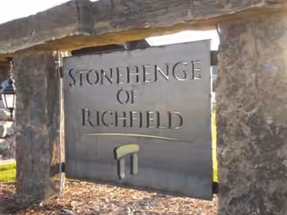 Stonehenge of Richfield entrance sign between large stone pillars.