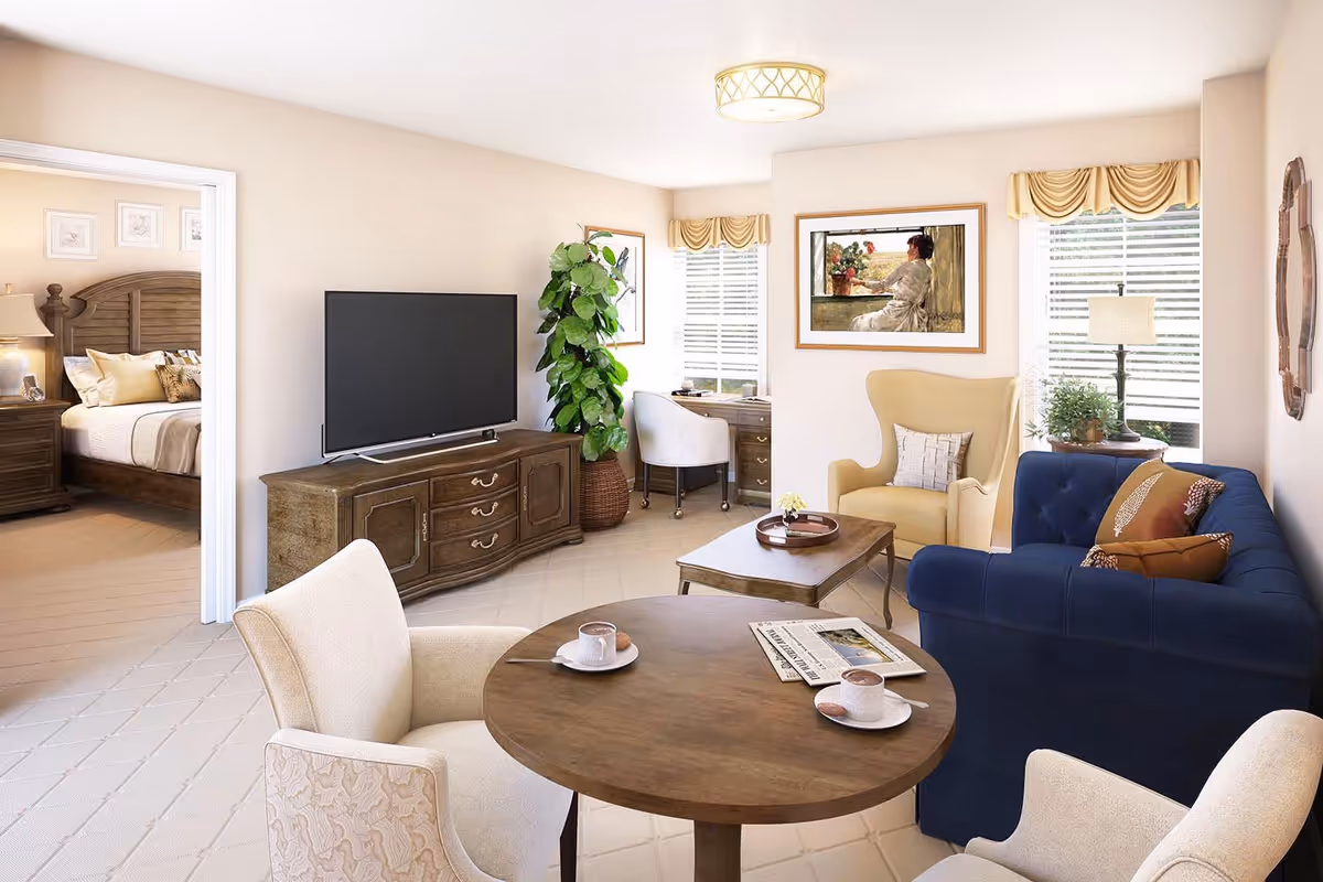 A cozy living room with a round wooden table set with two cups of coffee and a newspaper, surrounded by two beige armchairs. The room features a blue sofa with decorative pillows, a yellow armchair, a wooden coffee table, a TV on a wooden cabinet, a potted plant, and a desk with a chair near two windows with blinds and valances. A bedroom with a wooden bed and nightstand is visible through an open doorway.