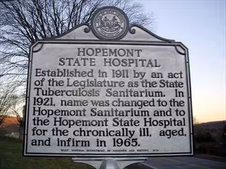 Historic Hopemont State Hospital sign outdoors with inscribed text.