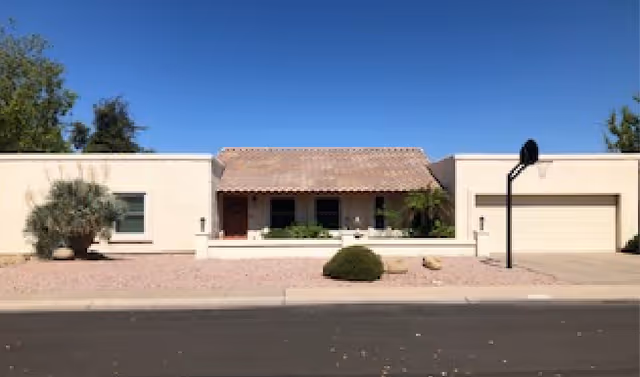 Single-story Grace Manor of Arizona exterior with entrance courtyard and driveway.