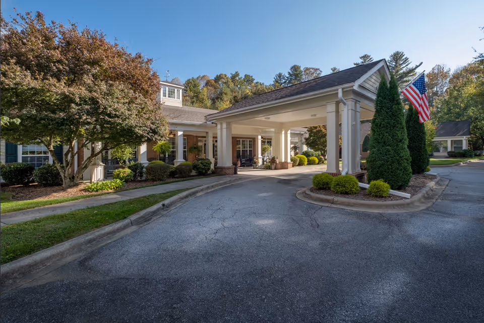 Exterior view of Carolina Reserve of Hendersonville entrance with porte-cochere and manicured landscaping.