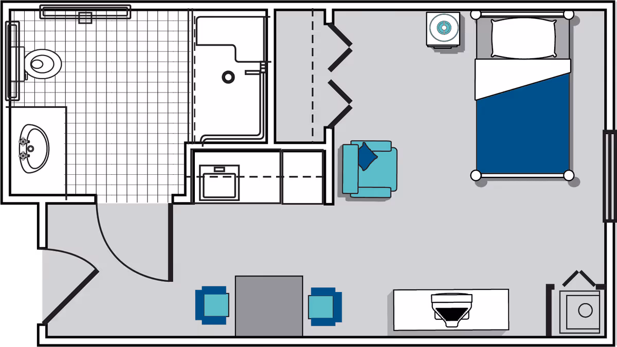 Floor plan of a senior living facility unit showing a bedroom with a bed, armchair, and nightstand, a bathroom with a toilet, sink, and shower, and a small dining area with a table and two chairs.