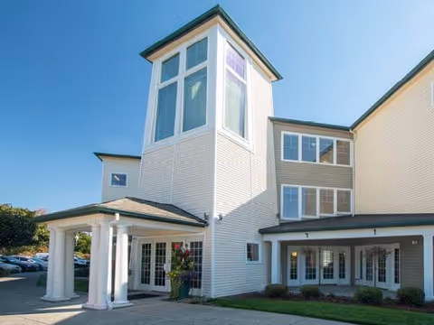 Exterior view of Avamere at St. Helens featuring a tall central tower and entry.