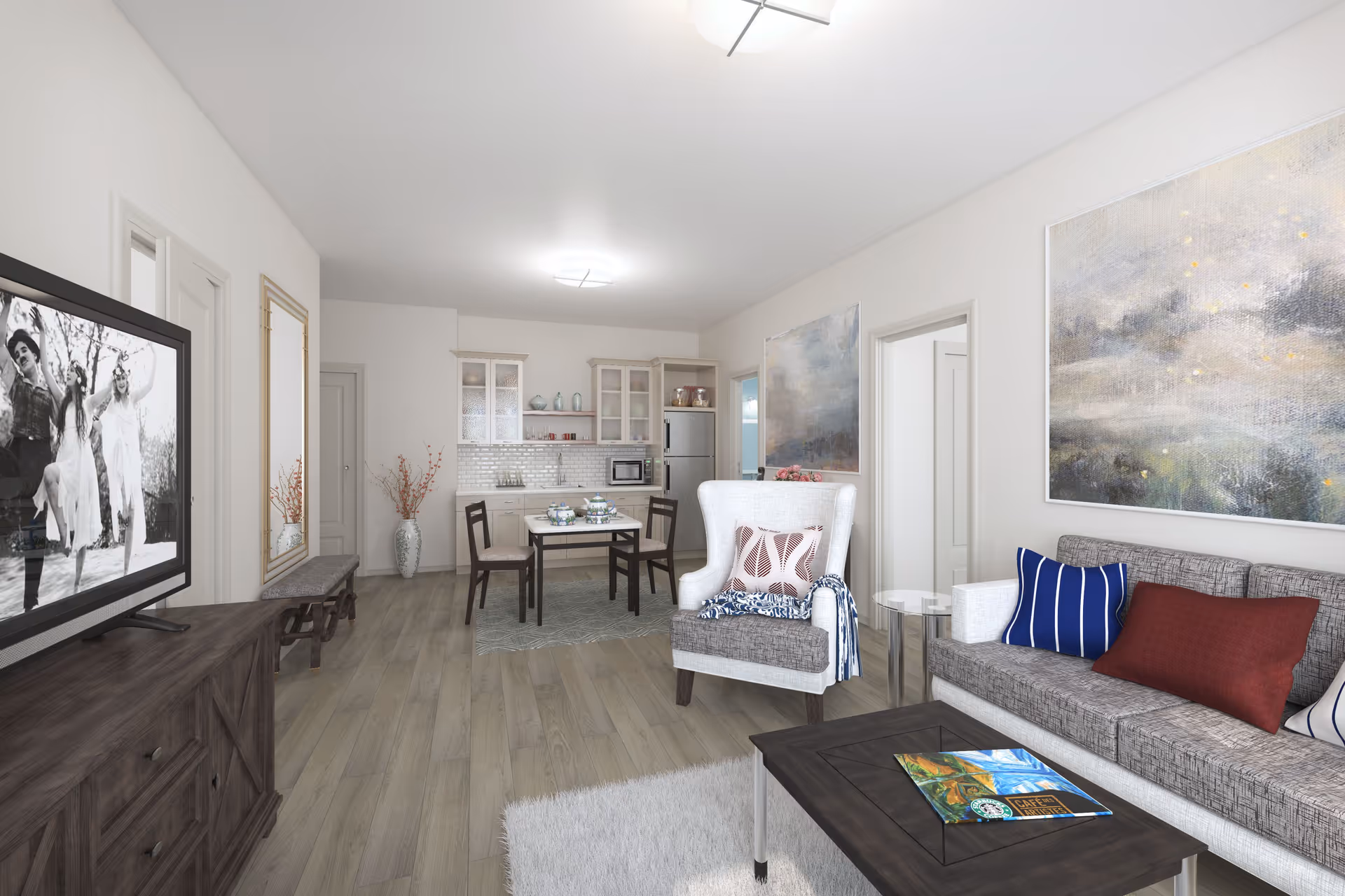 Open-plan living room and dining area with a sofa, armchair, coffee table, TV, and a small kitchen in the background.
