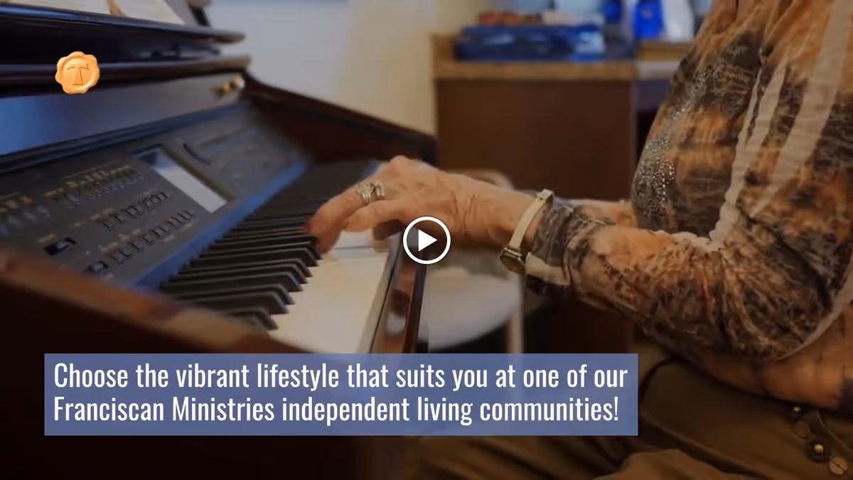 An elderly person playing an electronic keyboard piano, wearing a patterned long-sleeve shirt and a wristwatch. The image includes a text overlay promoting Franciscan Ministries independent living communities.