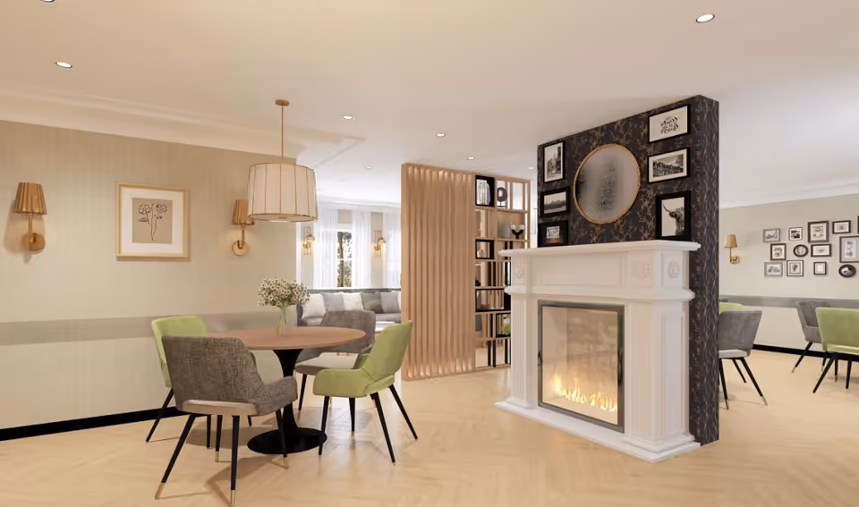 Open communal dining and lounge area with round tables and chairs, a decorative fireplace partition, and soft lighting.