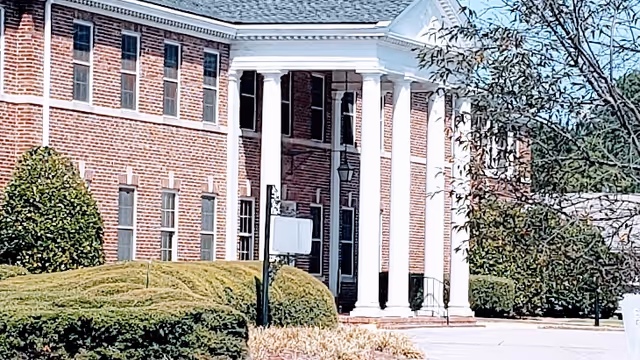 Exterior view of North Hill Nursing and Rehabilitation facility with brick walls and columns.
