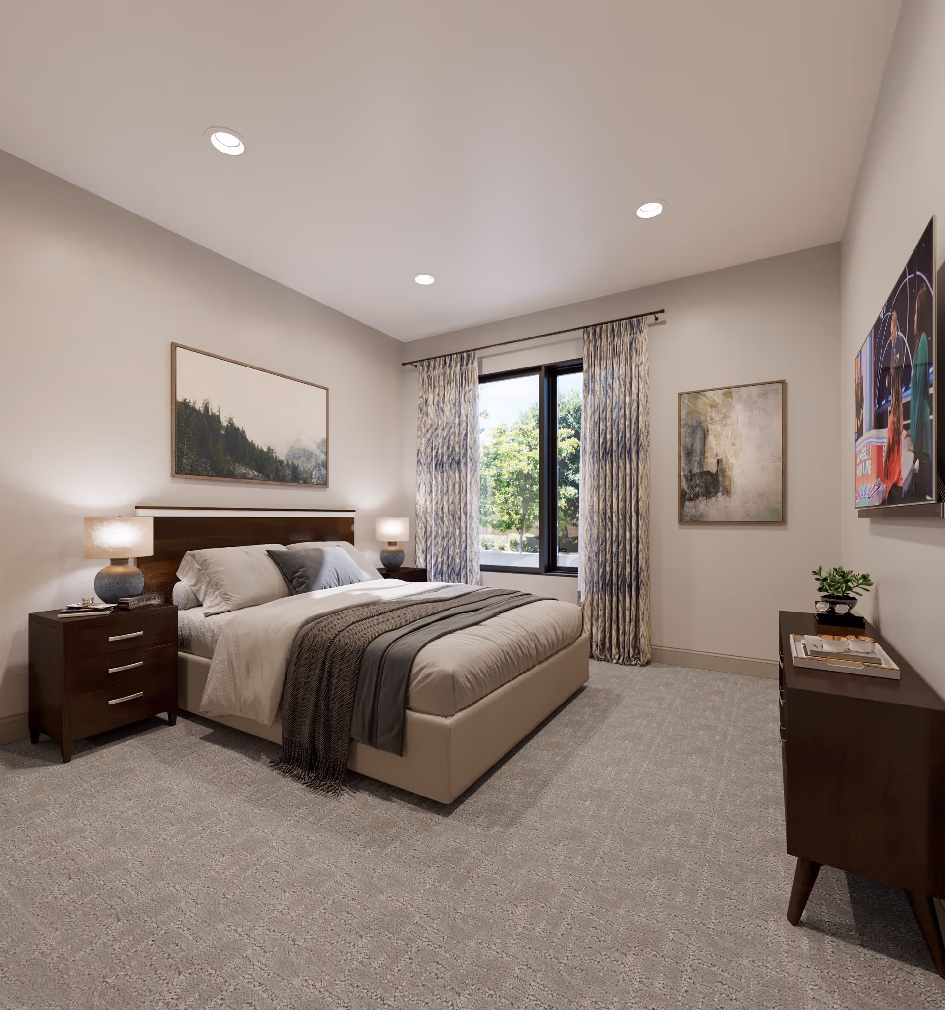 A modern bedroom with a large bed featuring beige and gray bedding, two bedside tables with lamps, a window with patterned curtains showing greenery outside, a dresser with a small plant and tray, and two framed artworks on the walls.