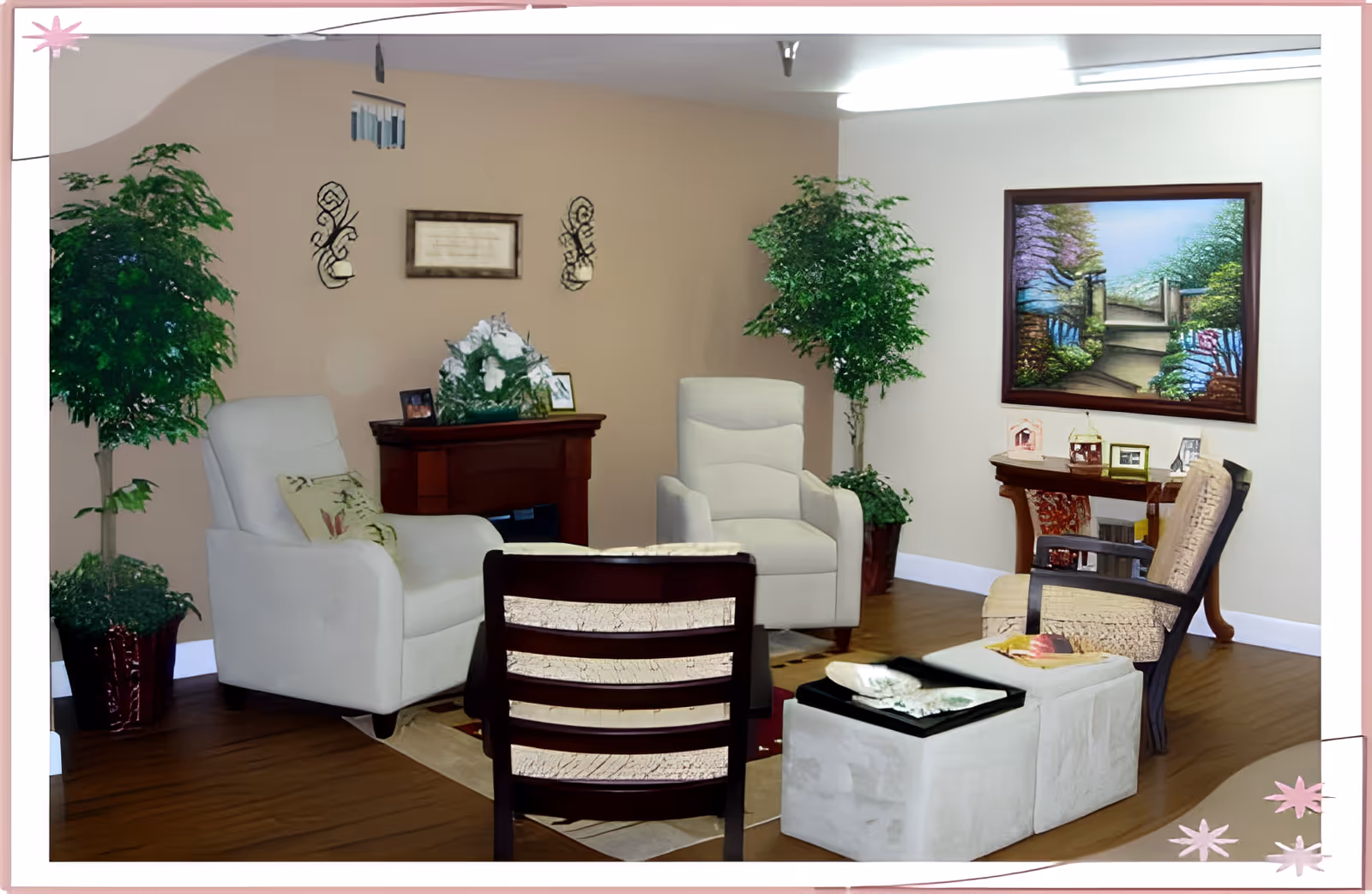 Warm communal living room with armchairs, potted plants, small tables and framed artwork on the walls.