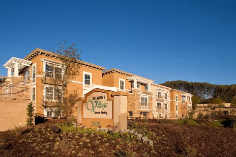 Exterior view of Belmont Village Senior Living Cardiff by the Sea with a stone sign.
