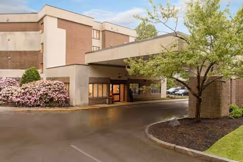 Exterior view of Life Care Center of the North Shore with entrance and landscaping.