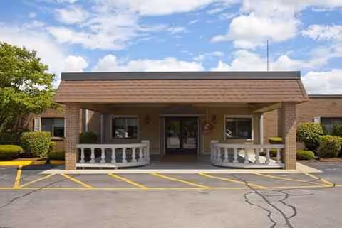Front exterior of Heritage Hills facility with covered entrance and parking area.