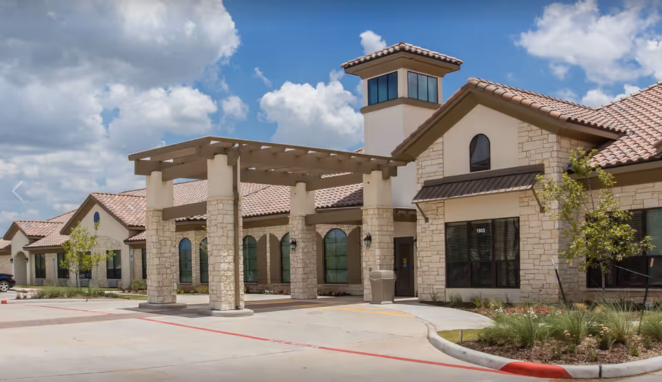 Exterior view of VibraLife El Paso facility with stone walls and a covered entrance.