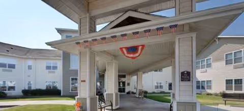 Front entrance of Brookdale senior living building with a covered drop-off area.