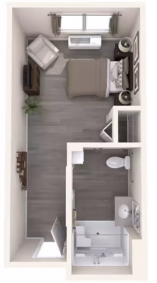 Top-down view of a small assisted living apartment layout featuring a bedroom area with a bed, nightstand, armchair, and TV, a bathroom with a shower, toilet, and sink, and a small closet space near the entrance.