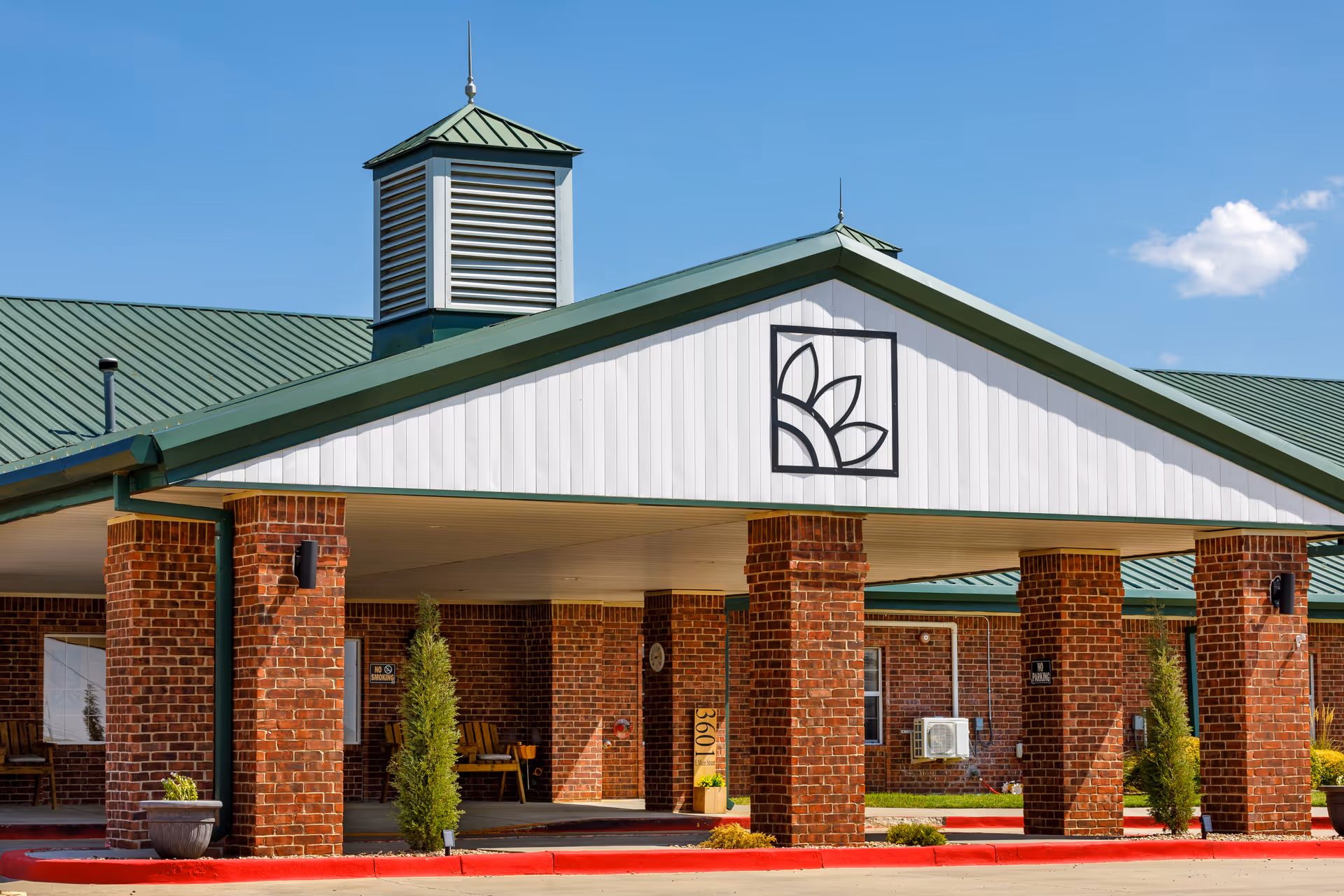 Exterior view of Homestead Assisted Living & Memory Care building with a decorative entrance.