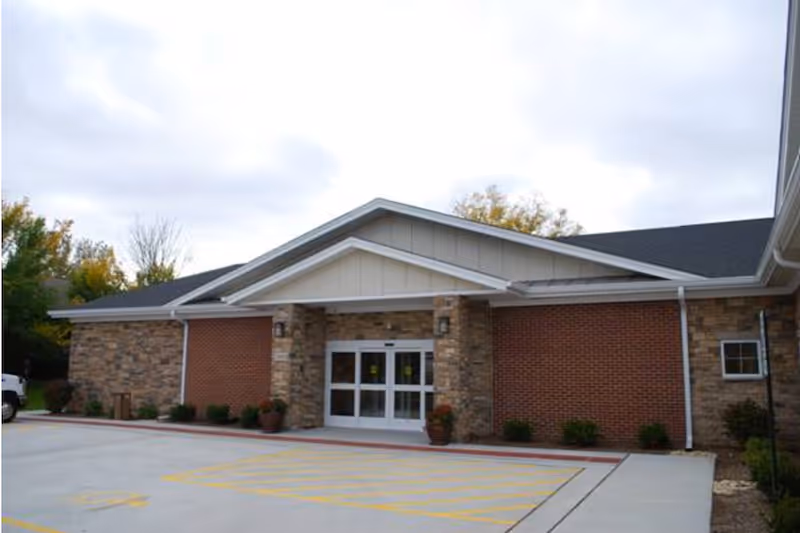 White Oaks at Spring Street exterior entrance with brick and stone facade.
