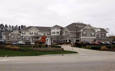 Exterior view of a Bickford senior living facility with landscaped grounds and curved driveway.