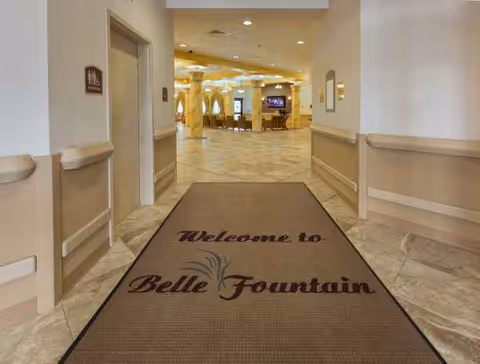 Indoor hallway with a large Welcome to Belle Fountain mat at the entrance.