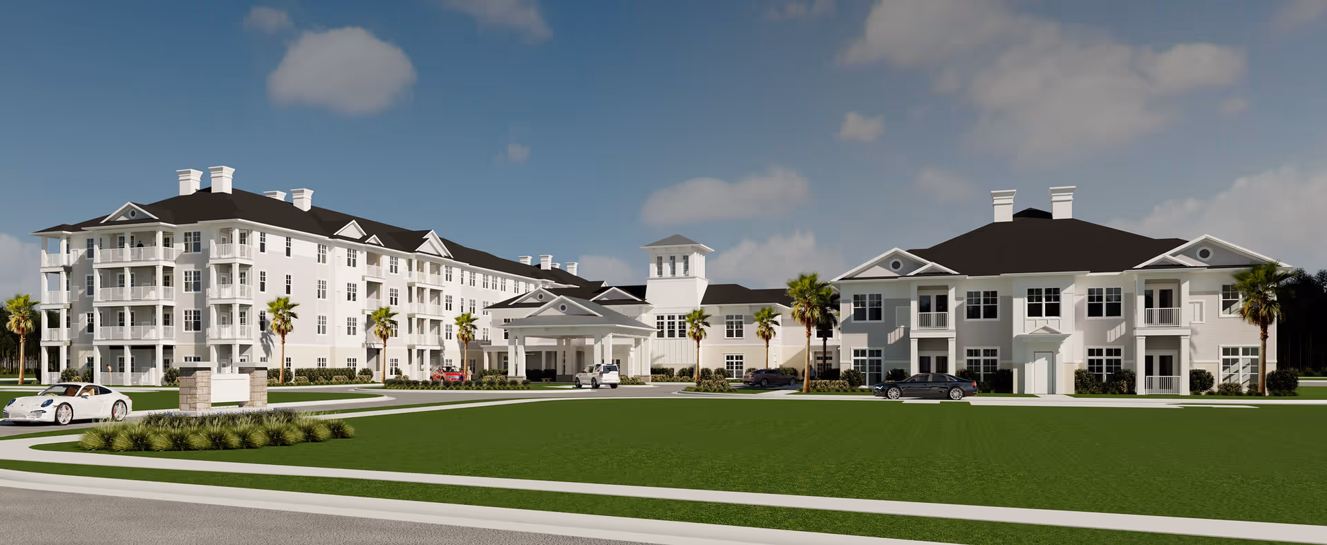 A large white senior living campus with multiple connected buildings and a green lawn.