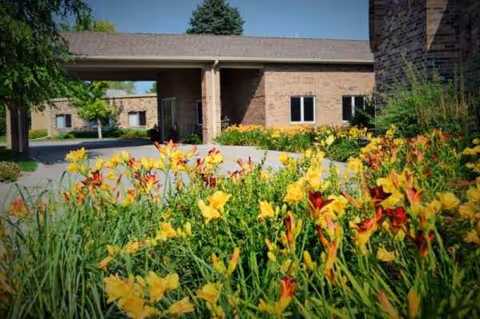 Front view of Heritage of Bel-Air with colorful flowers by the entrance