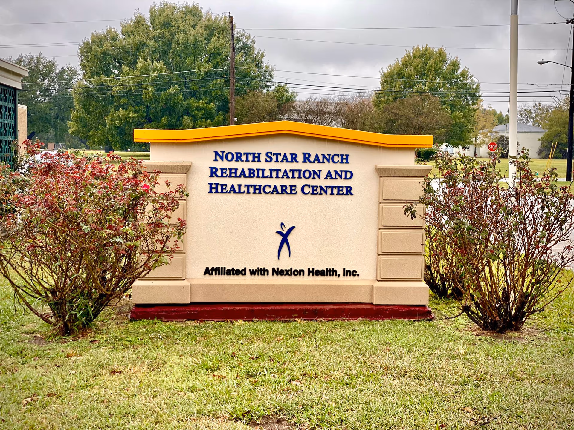 Sign for North Star Ranch Rehabilitation and Healthcare Center surrounded by greenery.