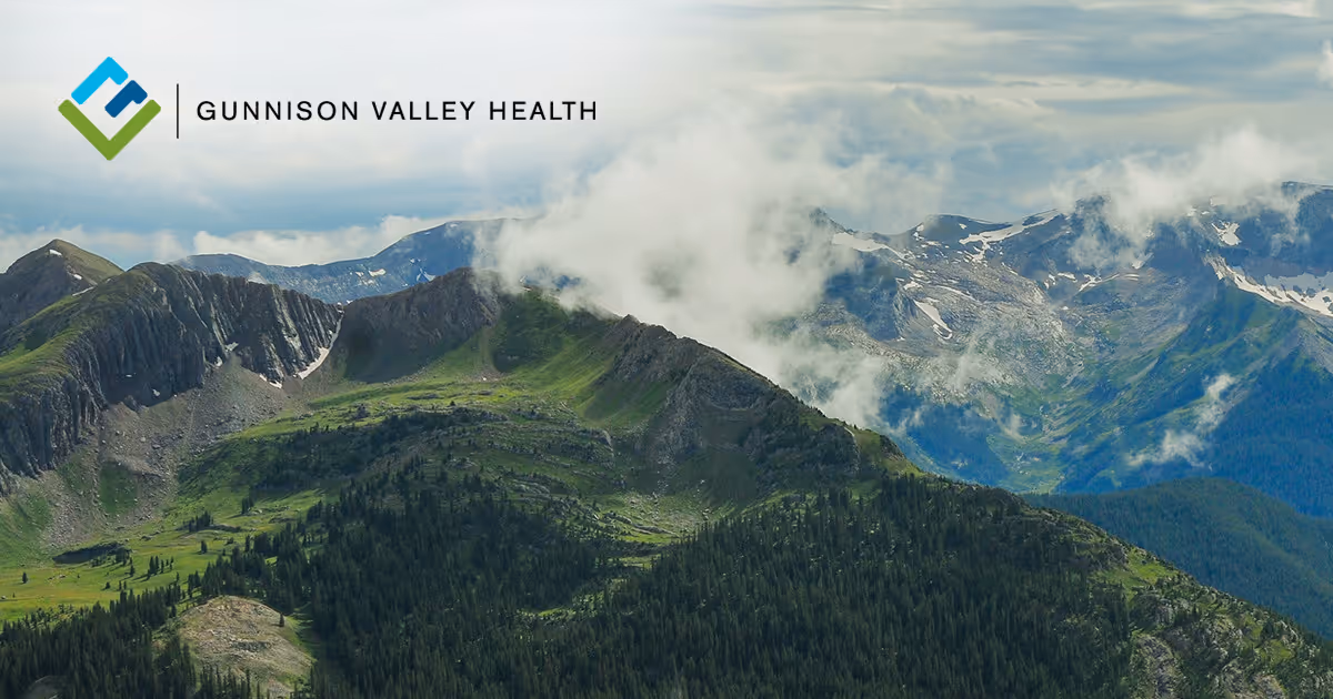 Scenic view of mountainous terrain under a cloudy sky.
