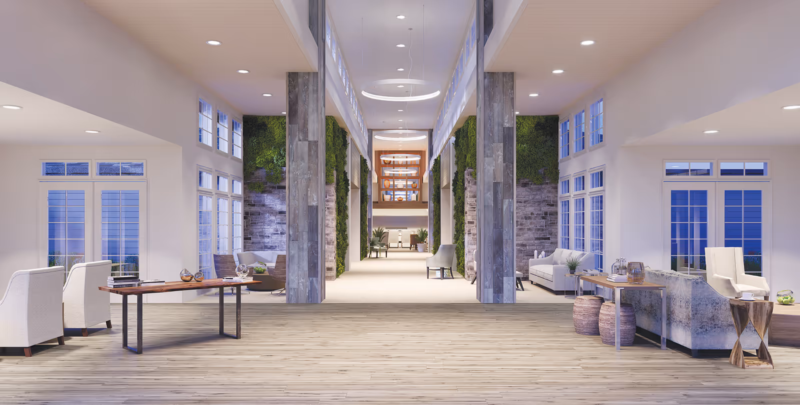 Spacious and modern interior lobby area with high ceilings, large windows, and contemporary furniture including chairs, sofas, and tables. The space features wood flooring, stone pillars, green vertical plant walls, and circular hanging light fixtures.