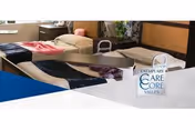 Several hospital-style beds arranged in an interior care facility room.