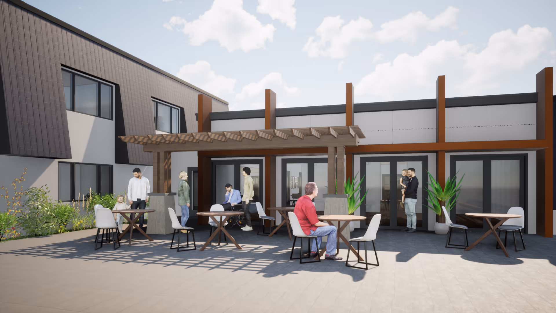 Outdoor patio area at Novellus Stockton Assisted Living with several people sitting and standing around tables under a wooden pergola. The building has large windows and doors, and there are plants placed near the entrance.