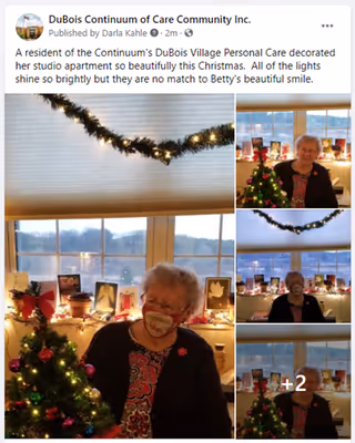 A collage of photos showing an elderly woman sitting in a decorated studio apartment with Christmas decorations. There is a small Christmas tree with ornaments and lights, holiday cards displayed on the windowsill, and garland with lights hanging above the window. The woman is smiling and wearing a festive outfit and a face mask in one photo.