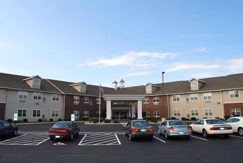 Front view of Heritage Woods of Manteno exterior with entrance and parking lot.