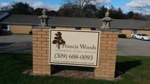 St. Francis Woods brick sign in front of a single-story facility.